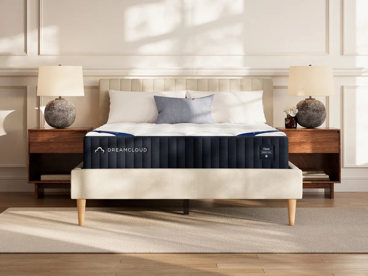 DreamCloud Classic Memory Foam mattress on a platform bed between two nightstands in a bright modern bedroom