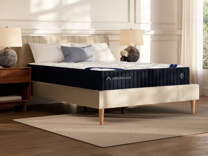 DreamCloud Classic Memory Foam mattress shown on a platform bed in a styled bedroom, on display at Magic Sleeper in Pottstown PA