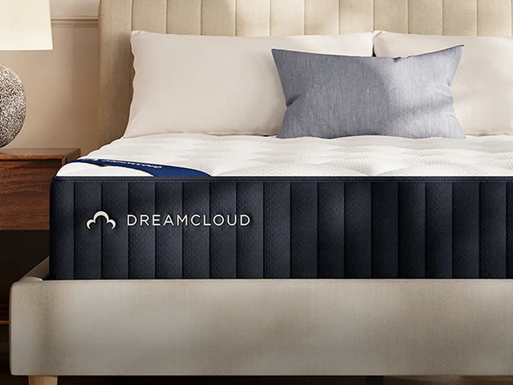 DreamCloud Classic Memory Foam navy mattress styled on a platform bed, available to try at Magic Sleeper in Pottstown PA