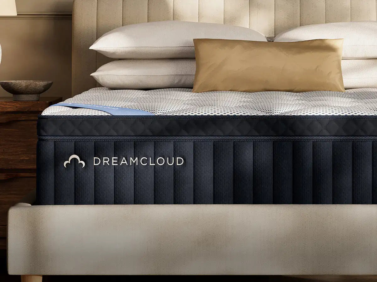 DreamCloud Premier mattress on a bed with pillows in a bedroom setting