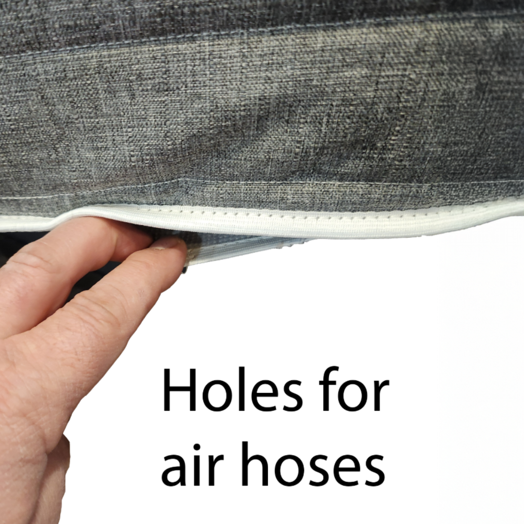 Hand holding a gray fabric with air hose holes for a Sleep Number bed