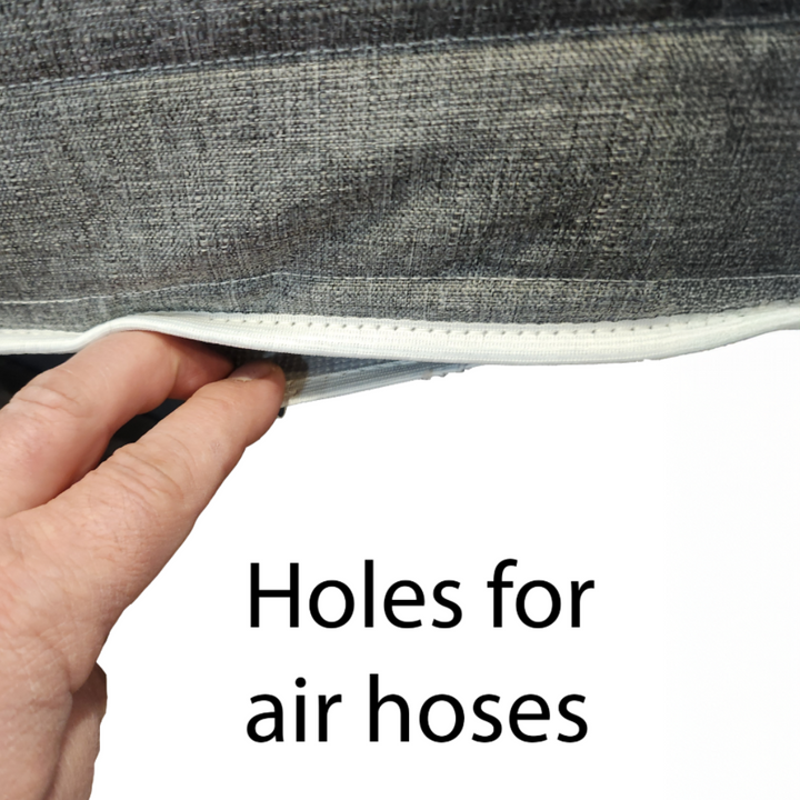 Hand holding a gray fabric with air hose holes for a Sleep Number bed