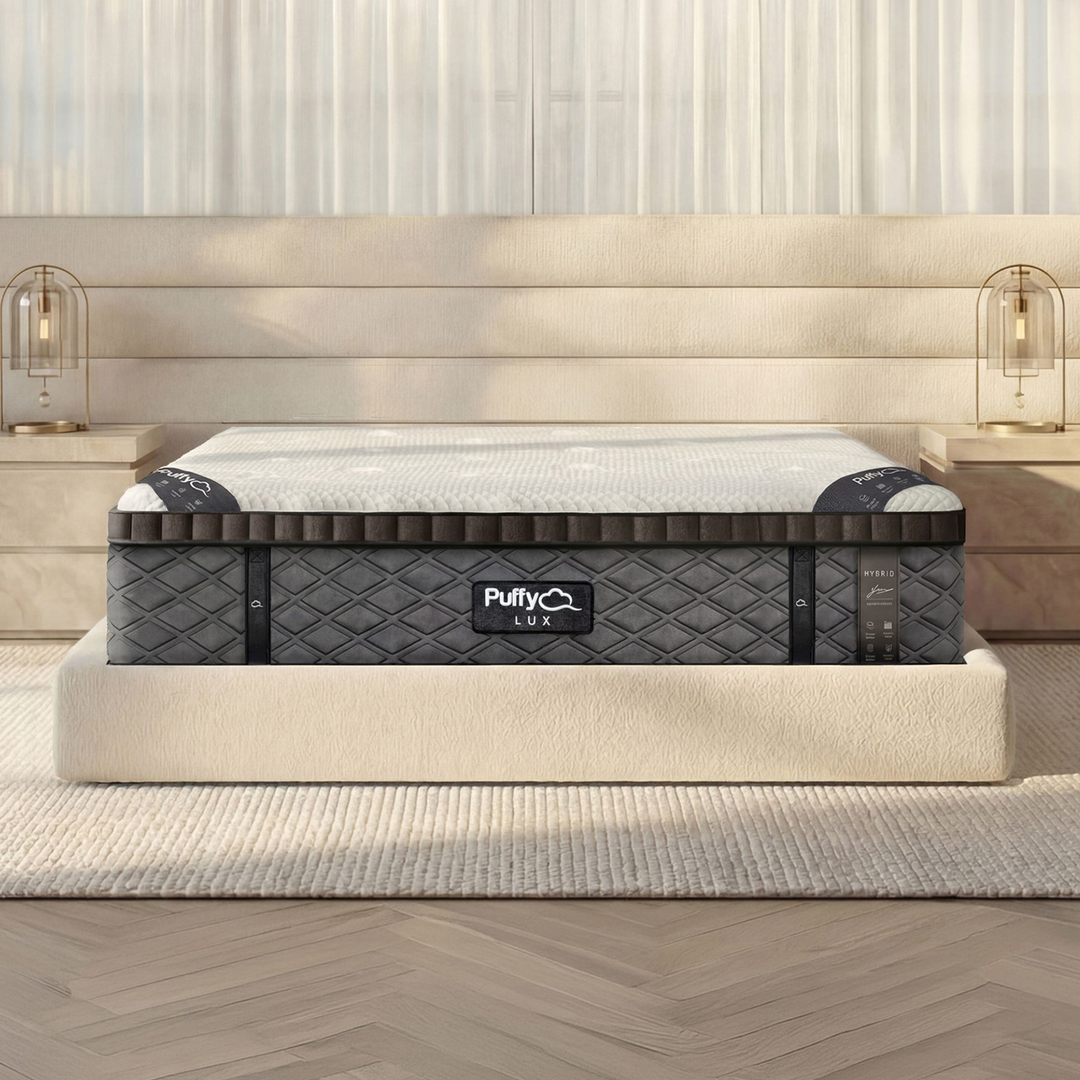 Front view of the Puffy Lux Hybrid 12-inch medium-plush mattress styled in a modern master bedroom, sold by Magic Sleeper in Pottstown, PA.