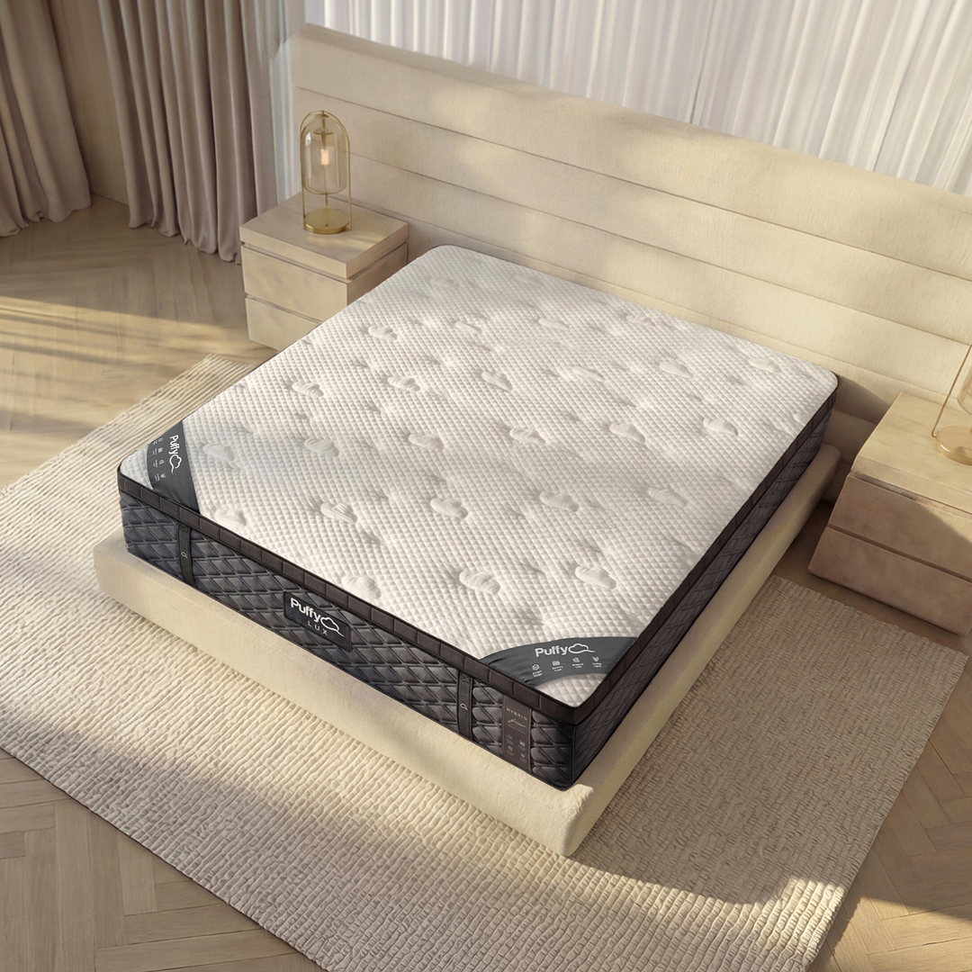 Angled corner view of the Puffy Lux Hybrid highlighting its 12-inch profile and contour-adapt coil base — available at Magic Sleeper, Pottstown, PA.