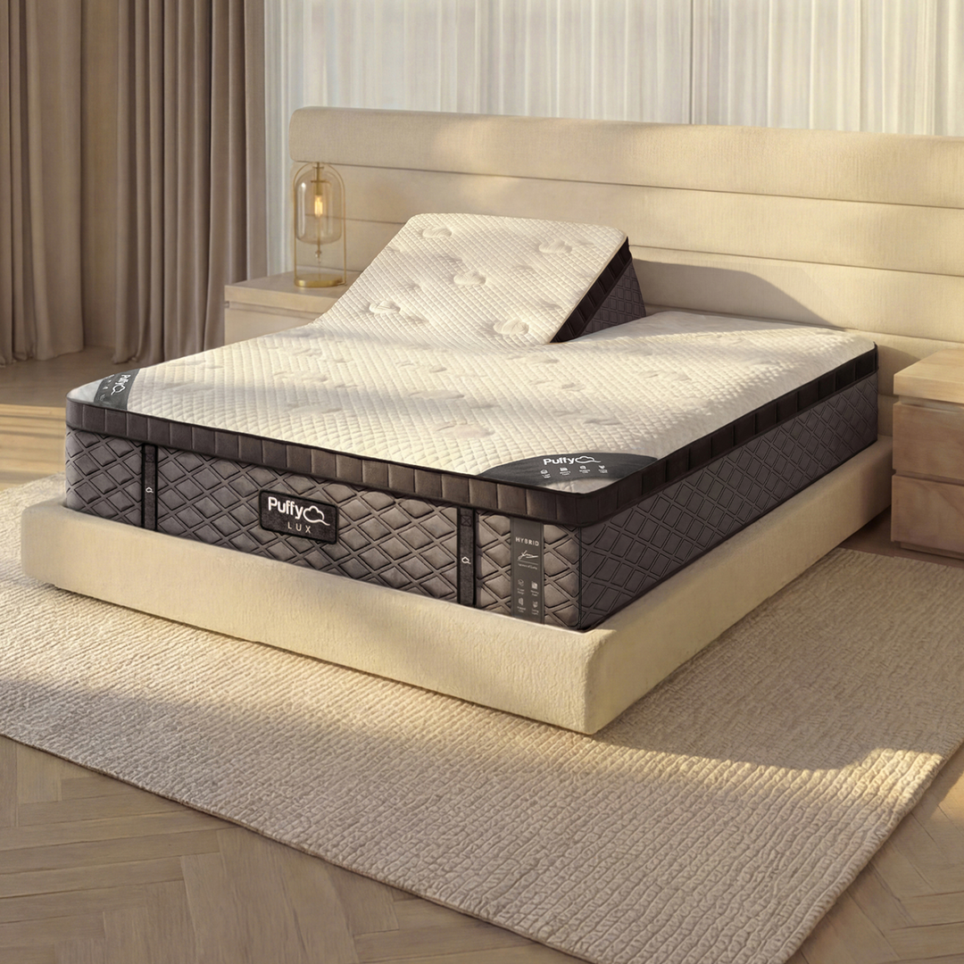 Split head Puffy Lux Hybrid shown on an adjustable base with head sections elevated, ideal for couples who want personalized sleep positions.