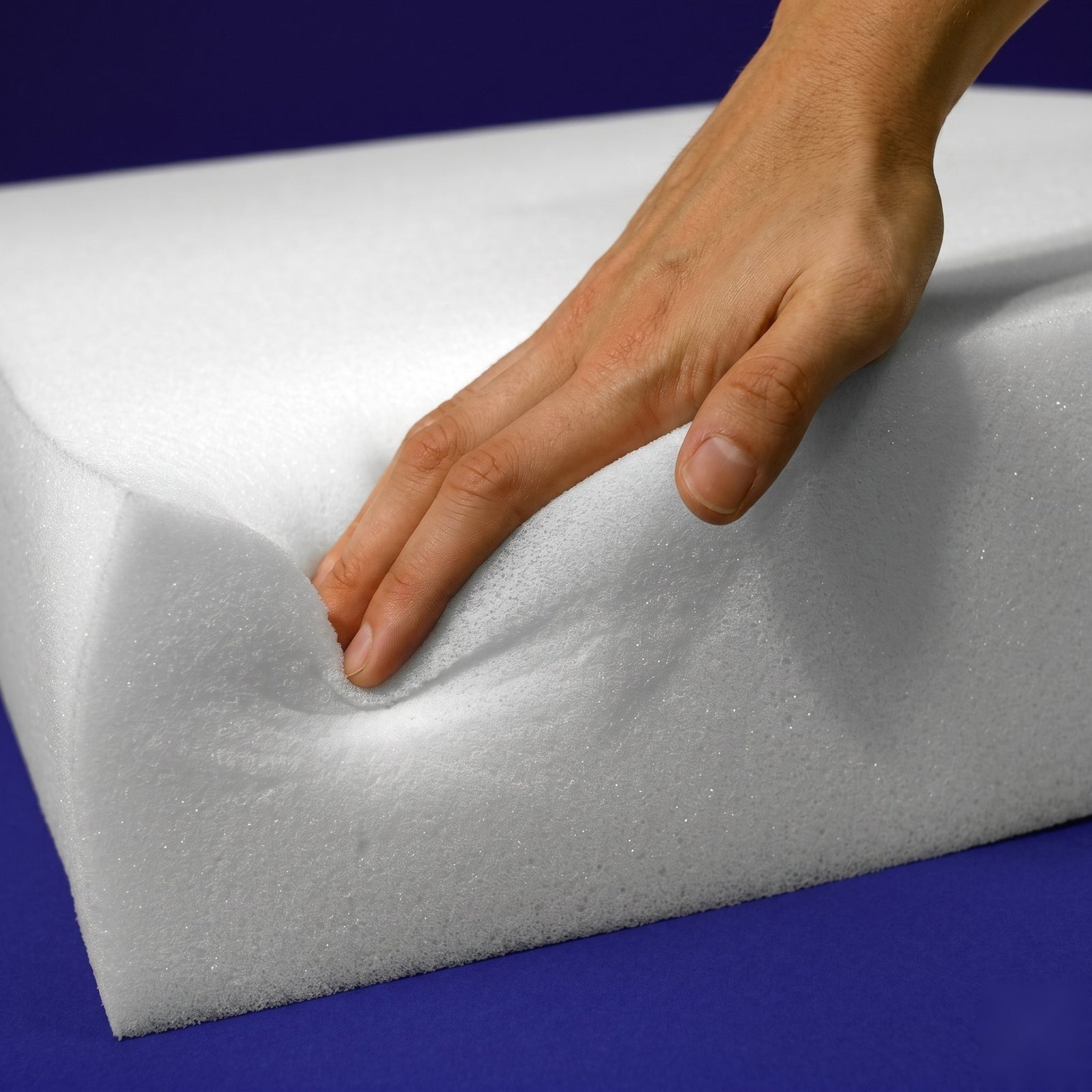 Hand pressing into King Split Head Flex Top replacement medium regular foam to show its medium-firm cushioning feel