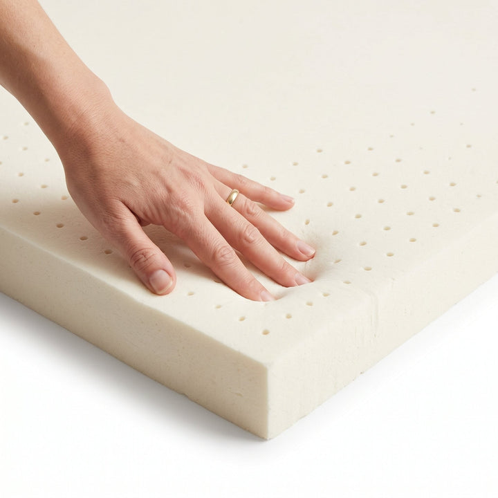 Hand pressing into King Split Head Flex Top natural latex replacement foam to show its soft, springy feel